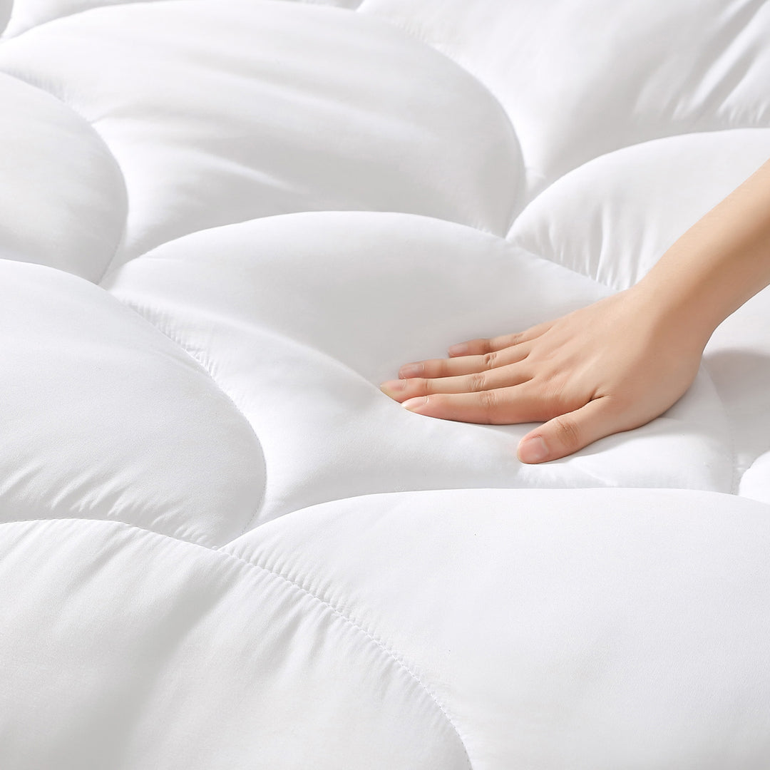 Hand pressing into the plush quilted surface of the Dr. Scholl&