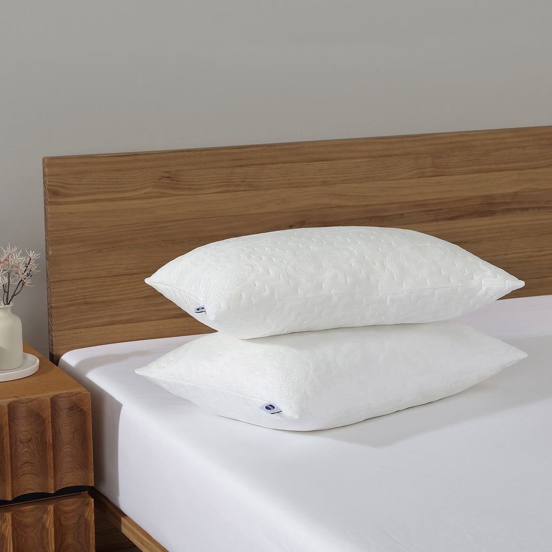 Dr. Scholl's™ CoolEase™ Memory Foam Pillows shown on a queen-size bed